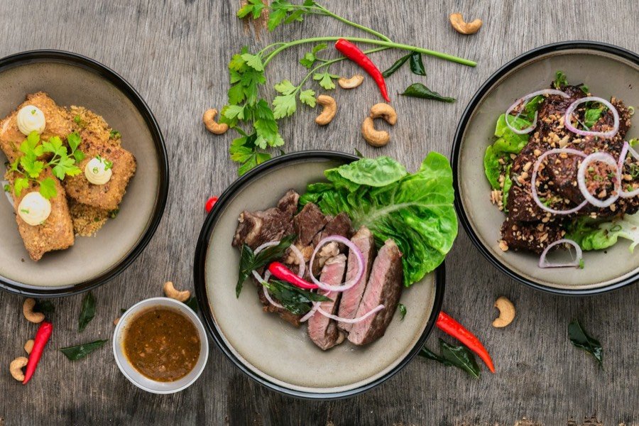 Freshly plated restaurant dishes on a wooden table